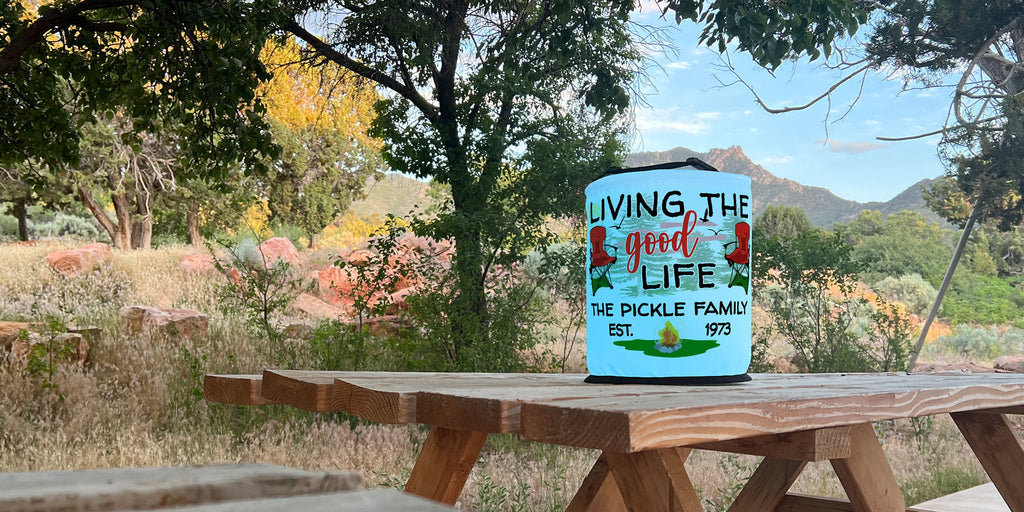 Personalized Living the Good Life LED lantern on wood picnic table. Beautiful mountain landscape in the background.